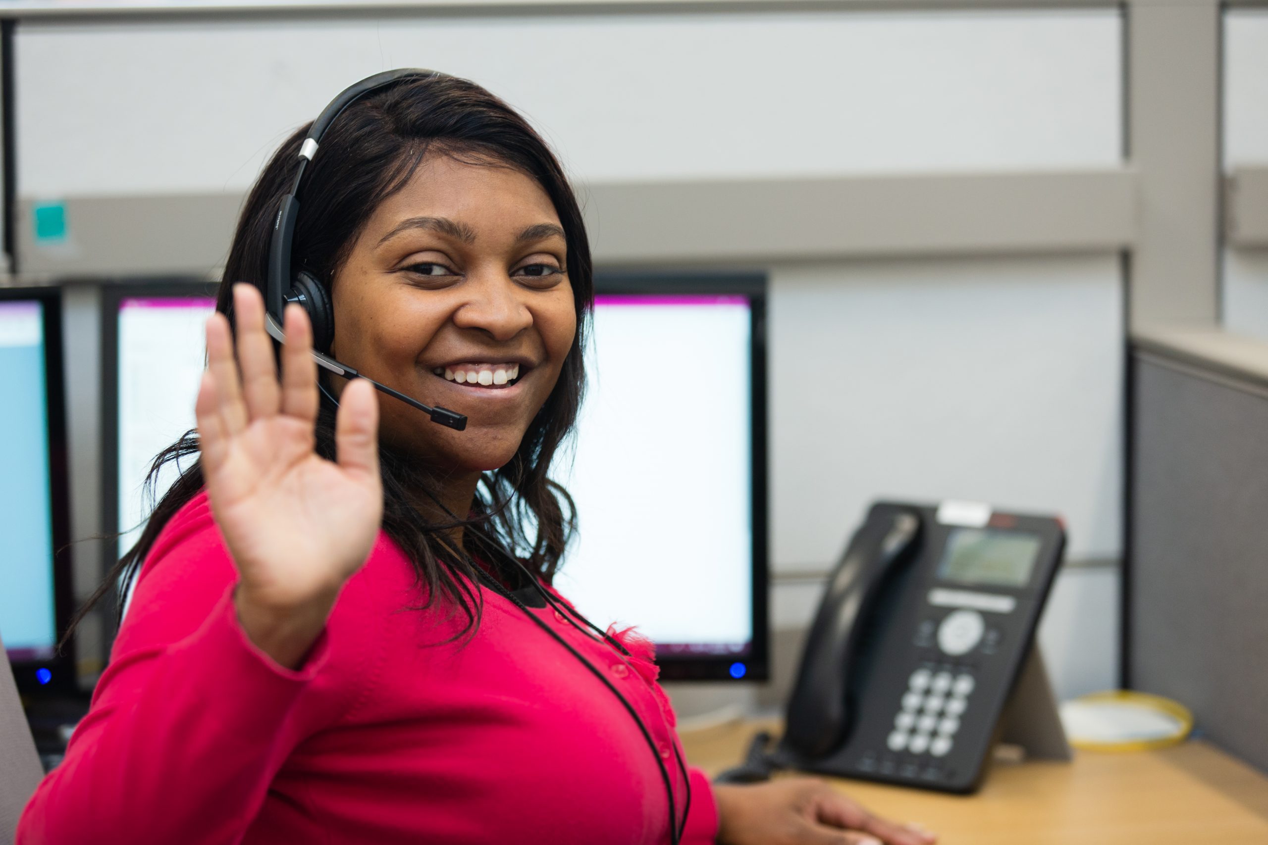 Woman working in a call center and waving