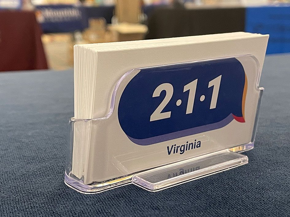 A card holder featuring business cards with the 211 Virginia logo.